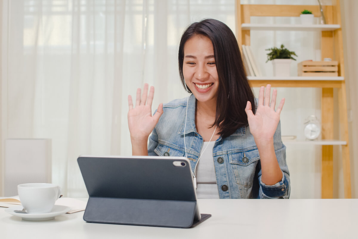 Woman smiling during video call on tablet