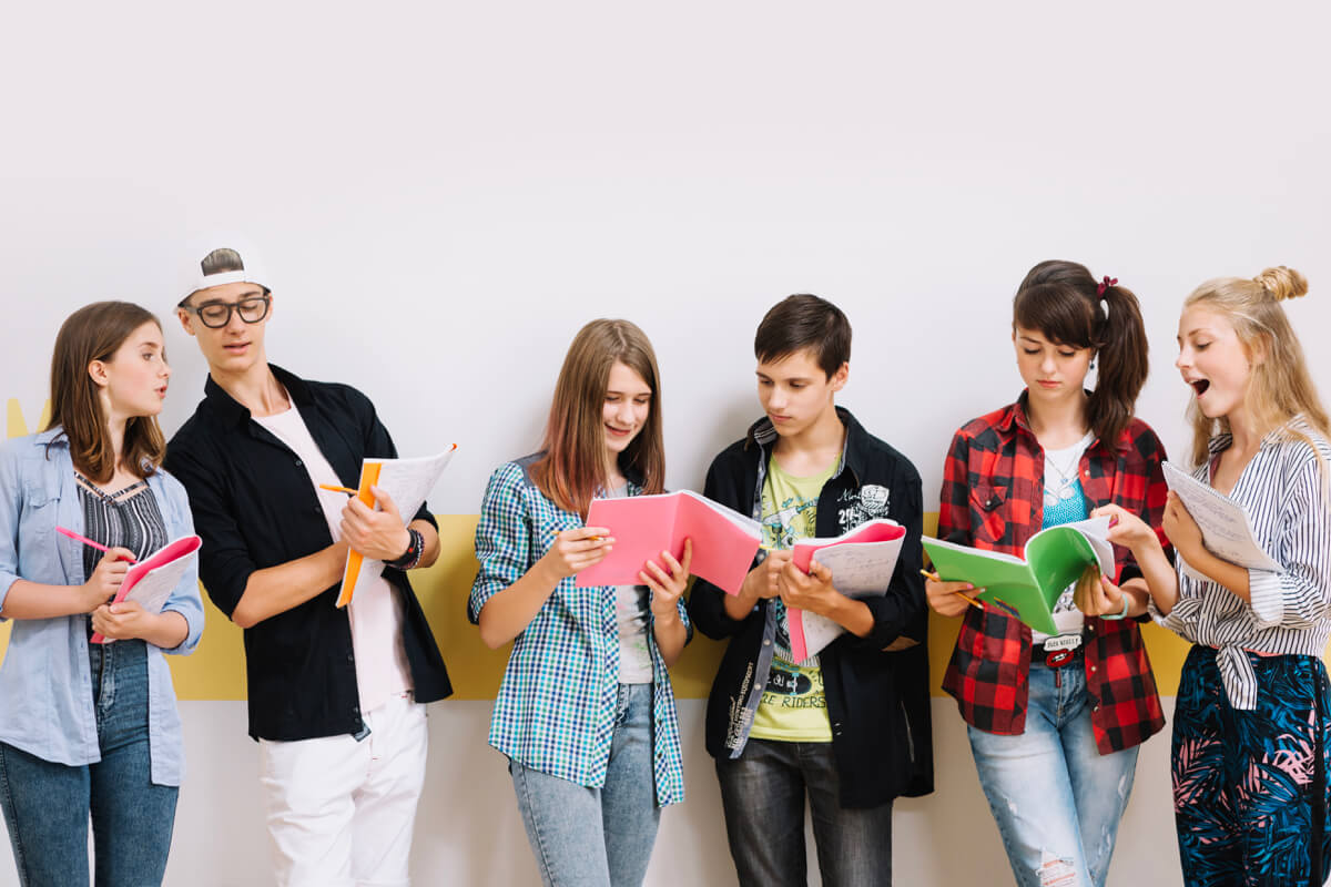 Teenagers studying together with notebooks