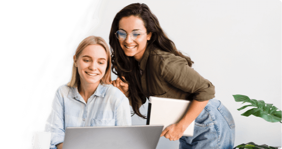 Two women collaborating on laptop project