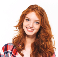 Smiling person with red hair and plaid shirt